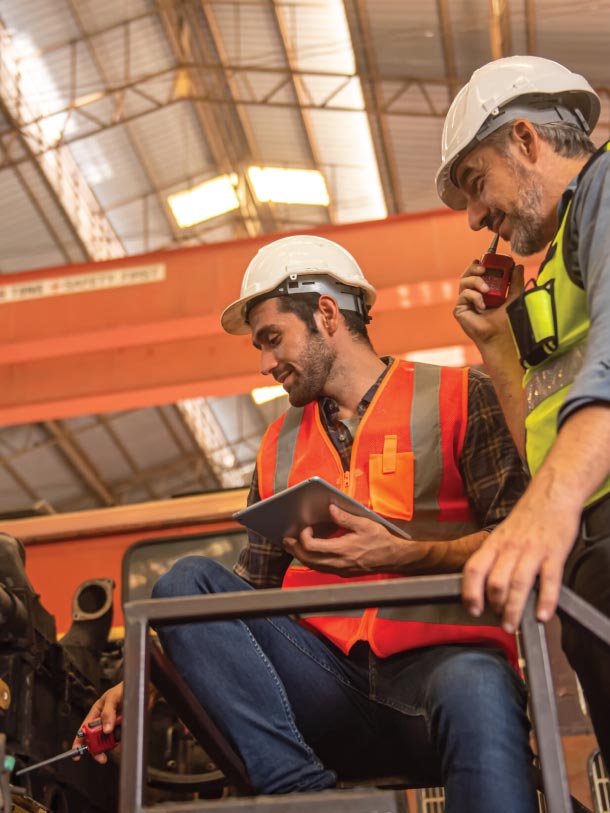 Workers conduct asset inspection and maintenance, ensuring compliance through the FlexManager platform.