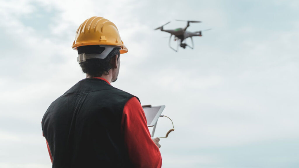 Professional conducting an elevated risk assessment, utilizing technology for Method Statements and site management reported through FlexManager software.