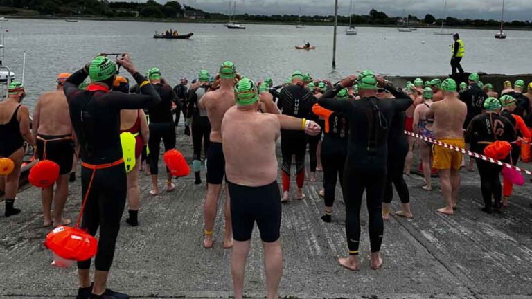 Participants for a swimming competition set themselves up at the starting line, taking all health and safety precautions prior to the event.