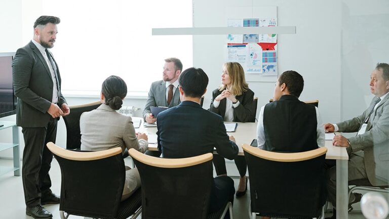 Group of professionals in a board room discussing health and safety standards.