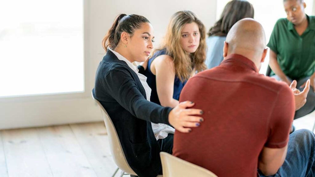 An employer demonstrating support to an employee in a shared space, allowing for openness and discussion of any issues.