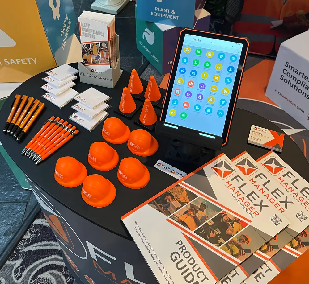Merchandise from an exhibition stand at an annual conference for NISO, with a tablet showing off the new stand and a product guide displaying different solutions.