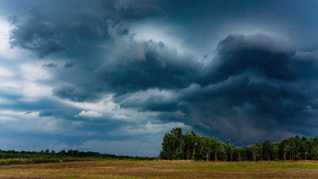 Storm clouds on an open landscape that represents the current orange weather warning in Ireland.