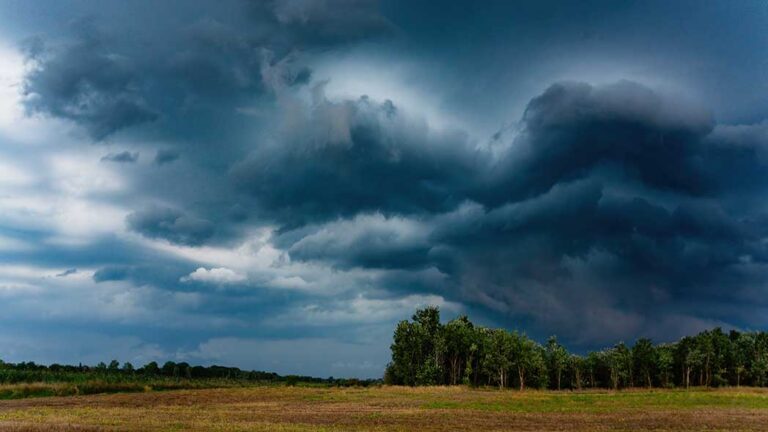 Storm clouds on an open landscape that represents the current orange weather warning in Ireland.