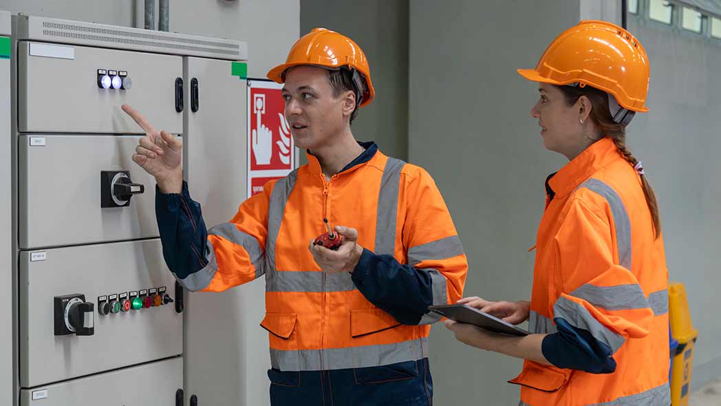 Electrical professionals investigating safety operations of a breaker to ensure compliance.