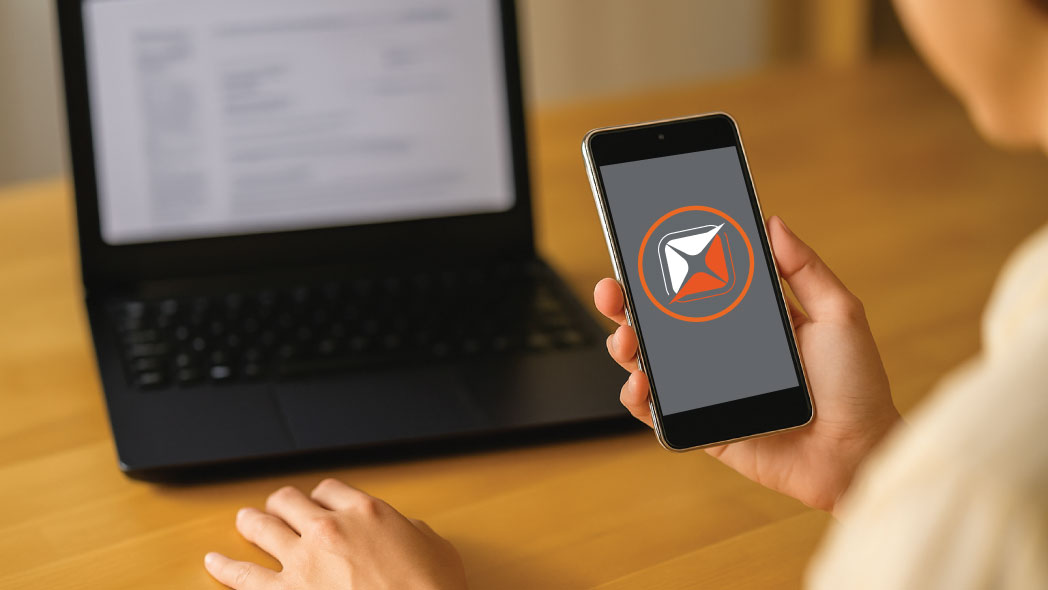 A user holding a mobile with a FlexManager logo on it, representing the mobile to desktop capabilities that are offered for field teams for administrative and managerial users.
