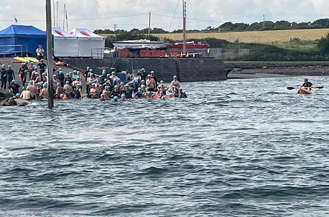 Swimmers entering the ocean at the atlantic lifeboat swim that was held in County Galway in July 2025