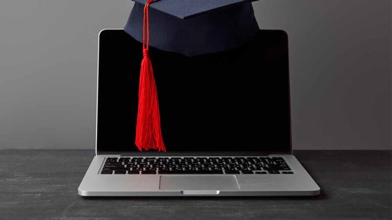 A graduation cap with a computer, symbolizing the progression of employees through FlexManager Training Manager tool.
