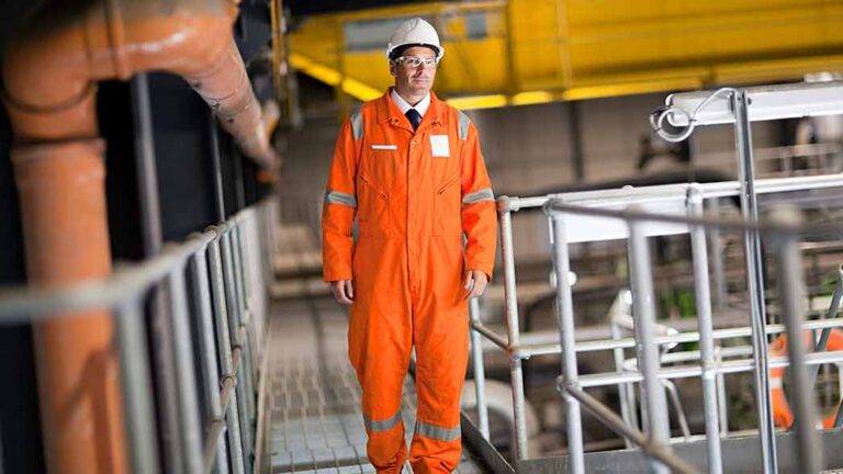 OHS professional on catwalk of HSEQ environment maintaining standards.