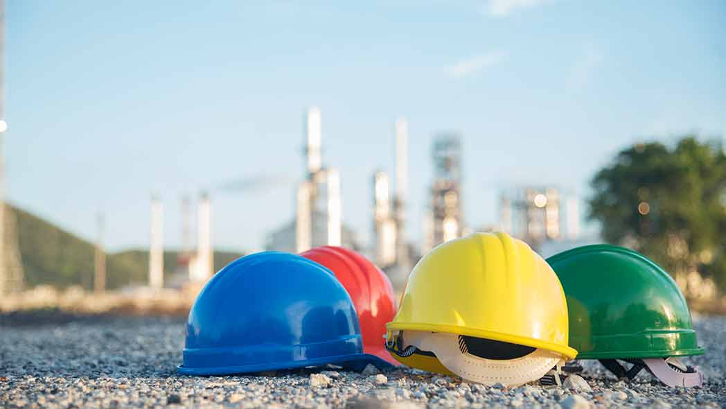 EHS helmets to represent safety compliance in the construction industry.