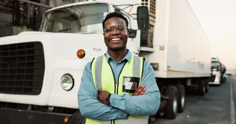 Fleet coordinator standing in front of a vehicle.