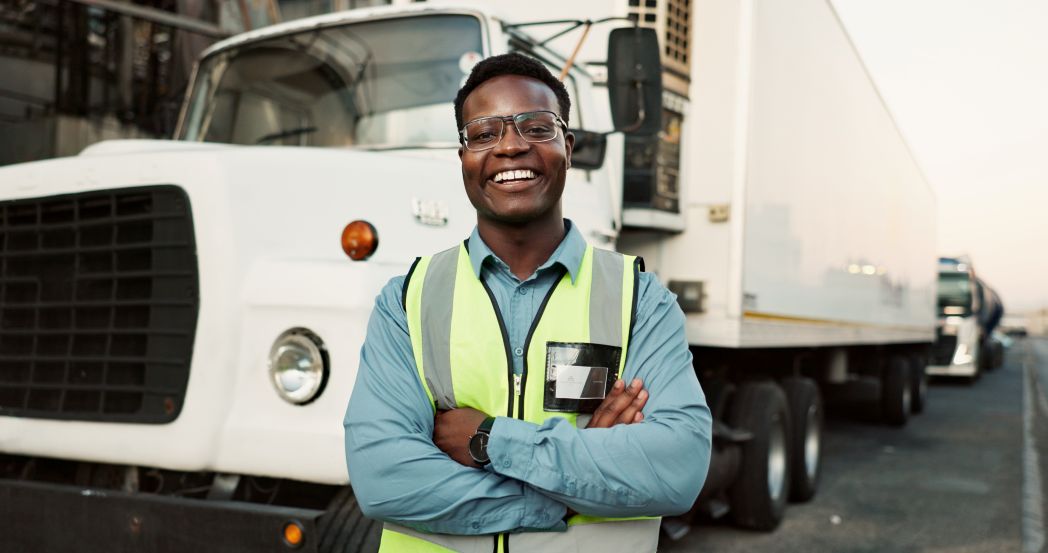 Fleet coordinator standing in front of a vehicle.
