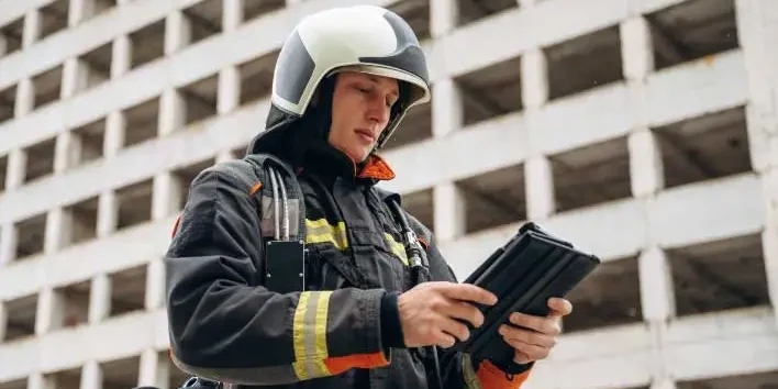 Solutions-For-Emergecny-Services-Interschutz-2026 Emergency Services Professional using tablet with smarter compliance solutions for asset management