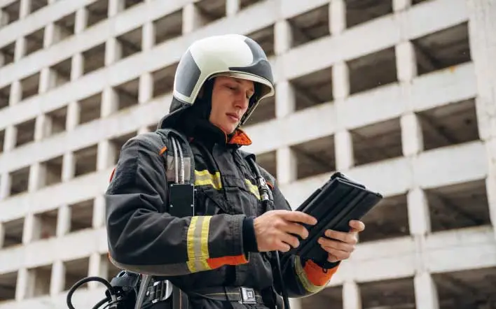 Emergency Services Professional using tablet with smarter compliance solutions for asset management