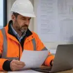 Facilities manager reviewing contractor certification records for asbestos and lead safety compliance