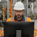 Industrial worker reviewing chemical safety training and PPE fit-testing records