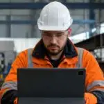 Construction quality inspector reviewing imported steel welding certification records