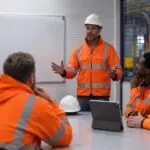 Employees participating in workplace safety training to improve safety training compliance and meet UK health and safety requirements.