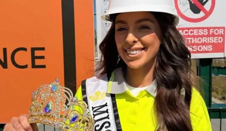 Female construction health and safety officer on site wearing a hard hat and high vis