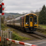 Passenger train approaching a level crossing, representing the safety risks reviewed after a railway near miss in North Yorkshire.