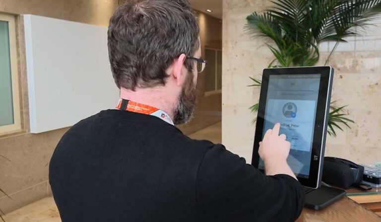 FlexManager Kiosk at a site entrance, where a worker checks in for attendance, training and induction records